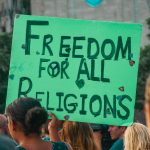 Placards reading Freedom for all religions appear