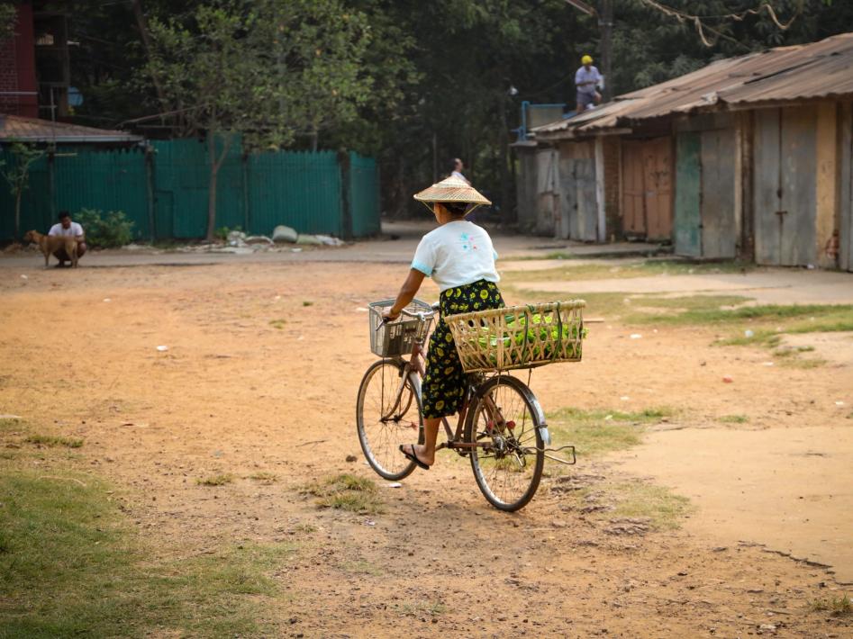 Foto-Magdalena-Vogt-2022-Kvinna-pa-cykel-Yangon-Myanmar-scaled-aspect-ratio-947-710